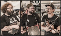 a group of men playing banjos in front of a microphone