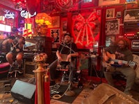 a group of people playing music in a bar